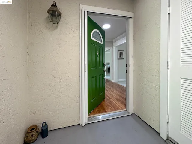 a dining room with furniture and a floor to ceiling window