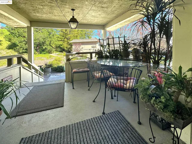 a view of a patio with iron fence