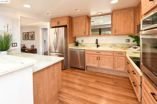 a kitchen with a sink stove and refrigerator