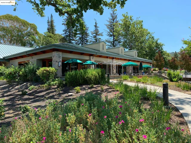 a view of a green field with wooden fence