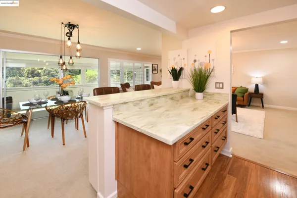 a kitchen with a table chairs and a view of living room