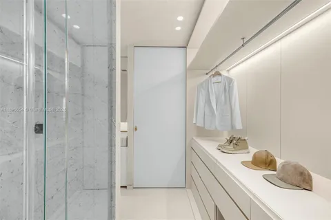 a bathroom with a double vanity sink mirror and shower