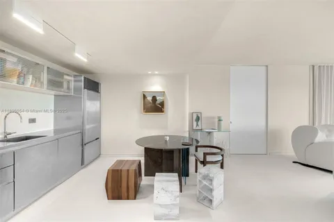 a room with furniture a rug and white walls