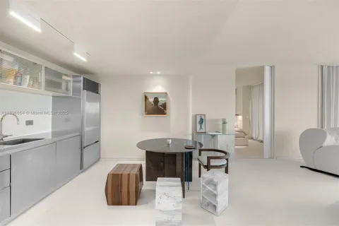 a room with furniture a rug and white walls