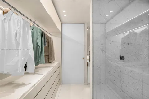 a bathroom with a granite countertop sink a mirror and shower