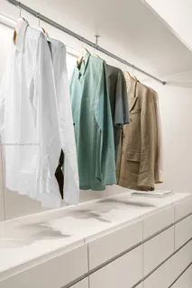 a view of walk in closet with clothes