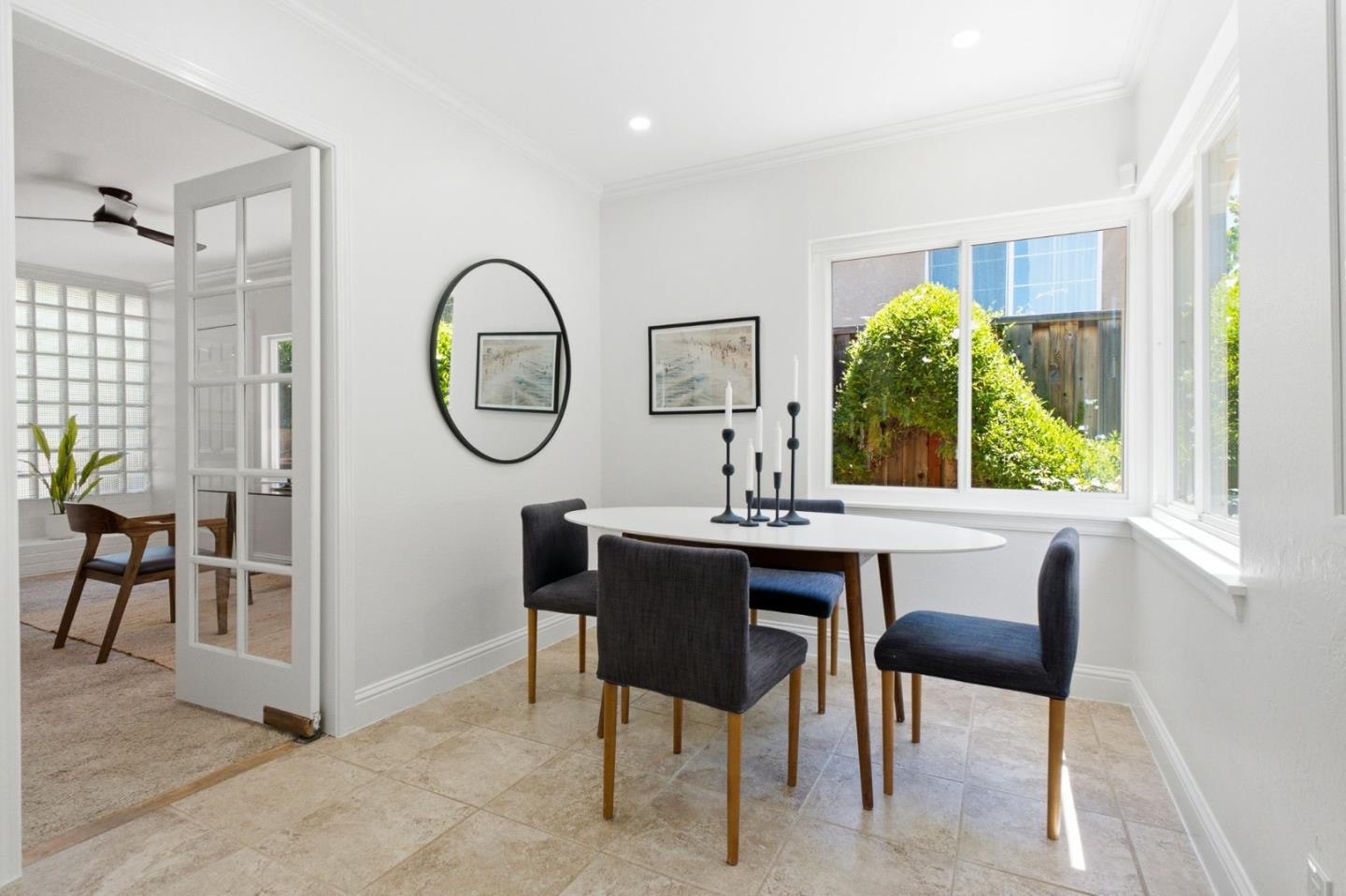 9858 Golf Links Road Oakland, CA 94605 - Photo 10 of 39 a view of a dining room with furniture window and wooden floor