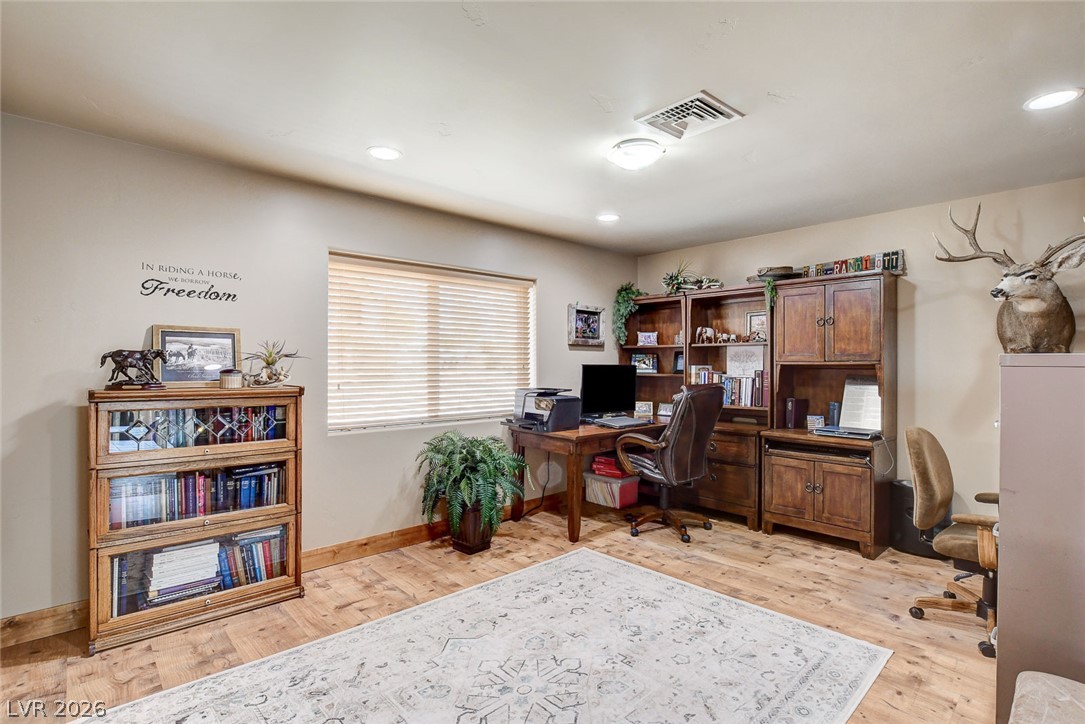 1950 Bowman Road Logandale, NV 89021 - Photo 22 of 81 Well-lit office space features rich wood-like flooring and updated lighting.