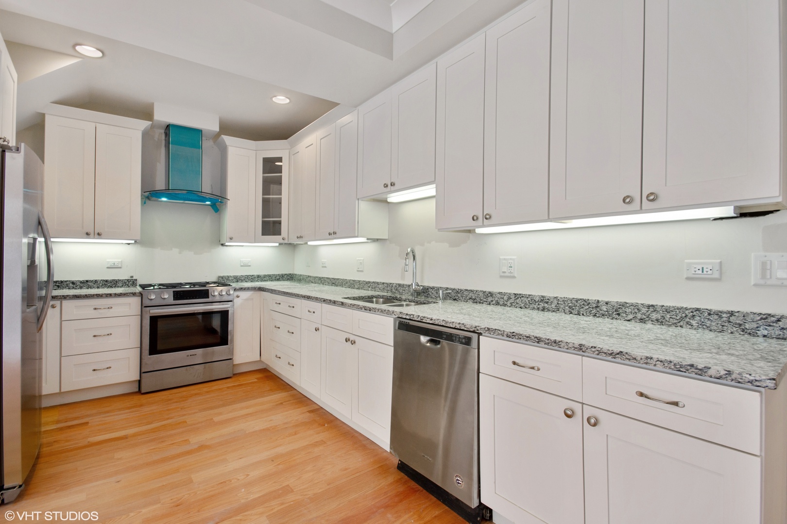 3750 North Racine Avenue, Unit 2 Chicago, IL 60613 - Photo 3 of 10 a kitchen with granite countertop white cabinets and white appliances