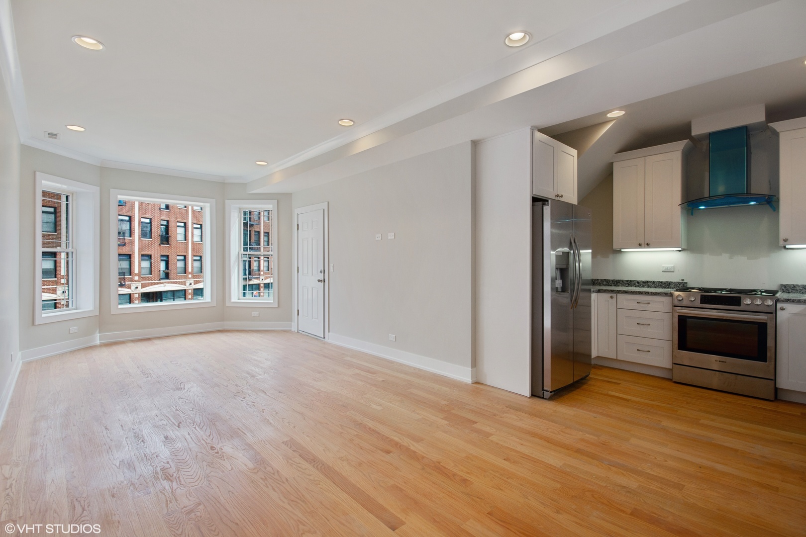 3750 North Racine Avenue, Unit 2 Chicago, IL 60613 - Photo 4 of 10 a kitchen with stainless steel appliances granite countertop a refrigerator and a stove top oven
