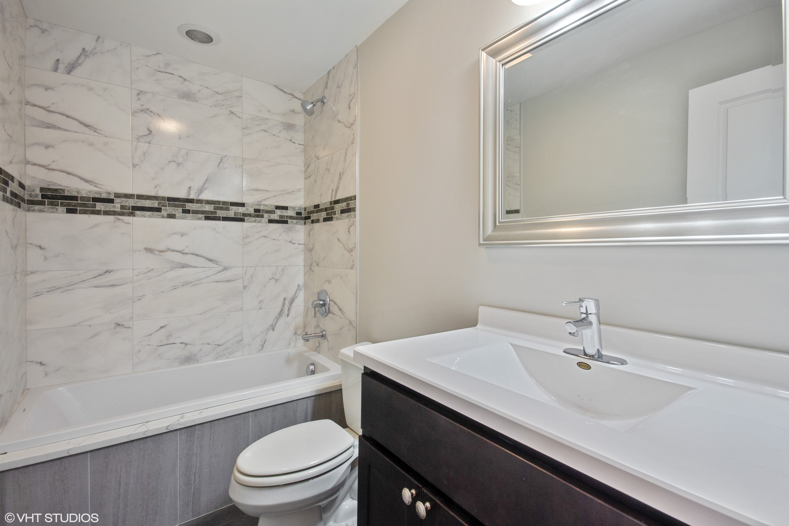 3750 North Racine Avenue, Unit 2 Chicago, IL 60613 - Photo 6 of 10 a bathroom with a sink a toilet and a bathtub