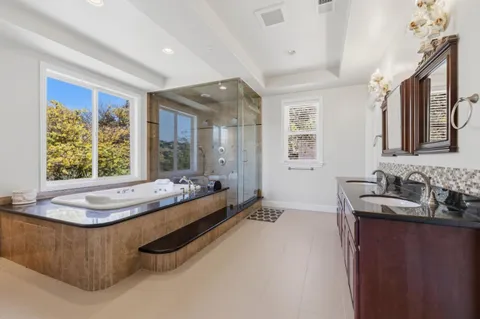 a large bed sitting in a kitchen next to a window