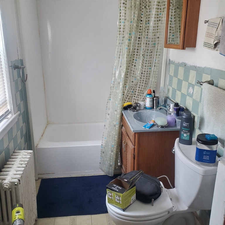 27 Halborn Street Boston, MA 02126 - Photo 4 of 20 a bathroom with a sink toilet and bathtub