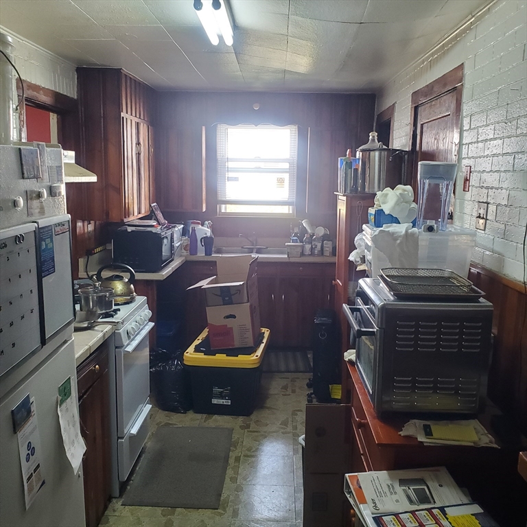 27 Halborn Street Boston, MA 02126 - Photo 7 of 20 a kitchen with a stove a refrigerator and a stove