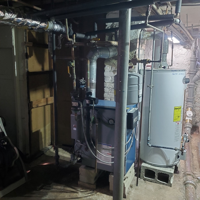 27 Halborn Street Boston, MA 02126 - Photo 8 of 20 a room with water heater and storage racks