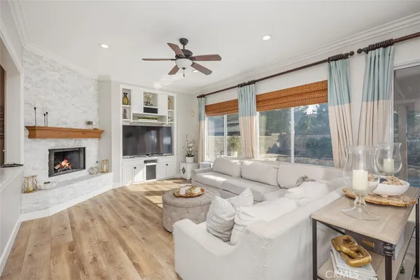a living room with furniture a fireplace and a flat screen tv