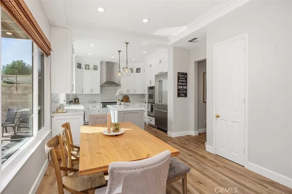 a dining room with furniture and a floor to ceiling window