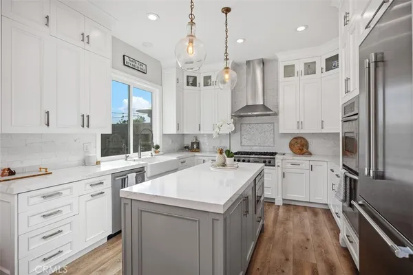 a kitchen with a stove a sink and a refrigerator
