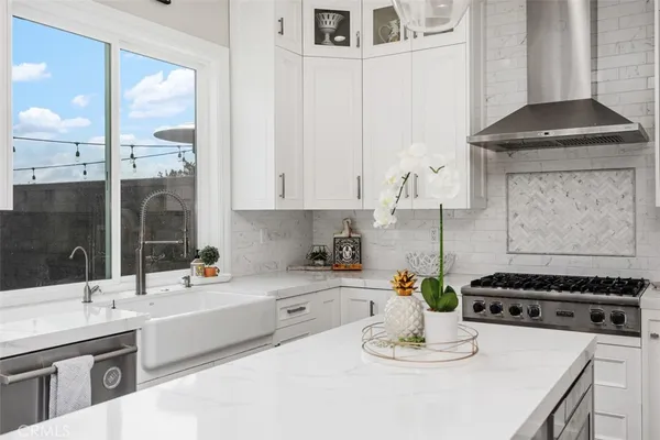 a kitchen with a sink stove and white cabinets