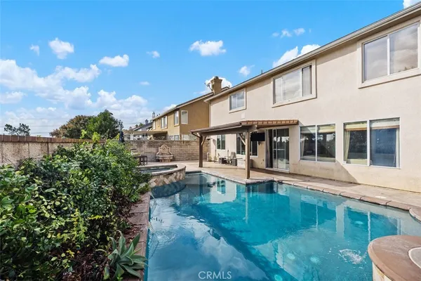 a view of a house with pool and sitting area