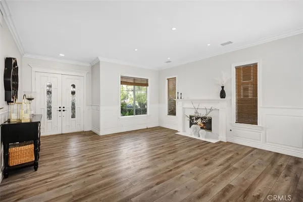 a view of empty room with wooden floor and fireplace