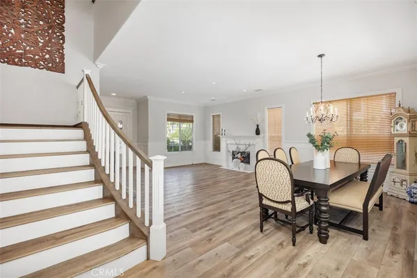 a dining room with furniture window and wooden floor