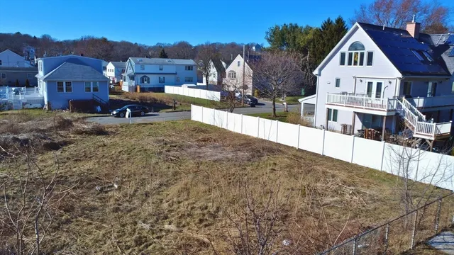 an aerial view of residential house with outdoor space and parking