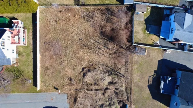 a view of a house with a yard and wooden fence