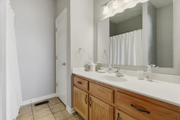 a bathroom with a double vanity sink and a mirror