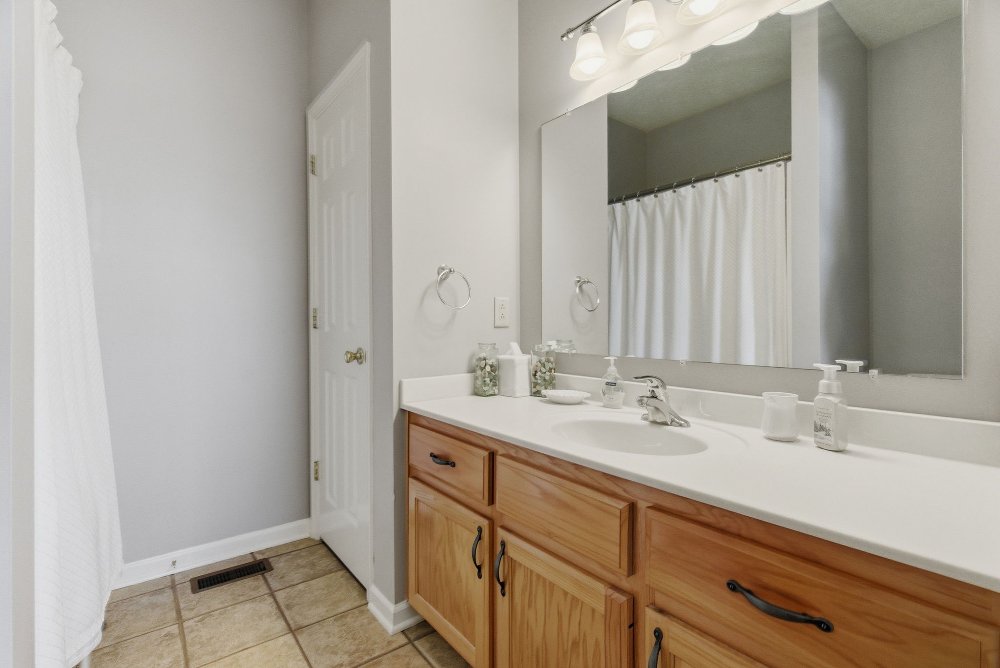 4357 Airport Road Springfield, TN 37172 - Photo 13 of 49 a bathroom with a double vanity sink and a mirror