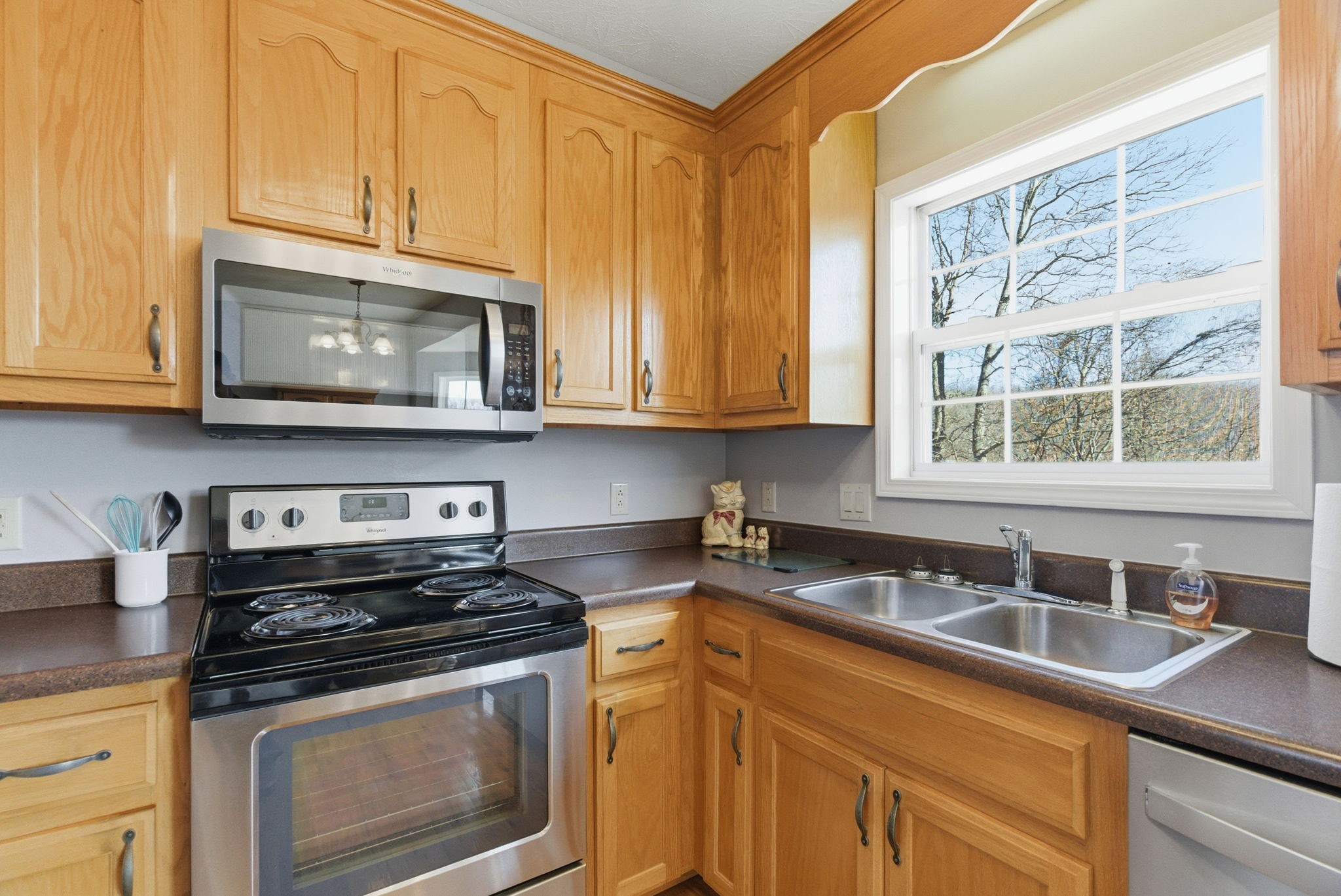 4357 Airport Road Springfield, TN 37172 - Photo 19 of 49 a kitchen with stainless steel appliances granite countertop a sink a stove a microwave oven and cabinets