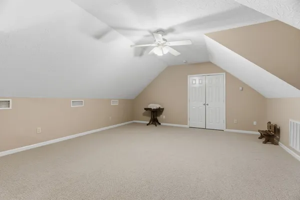 a view of a livingroom with furniture and staircase