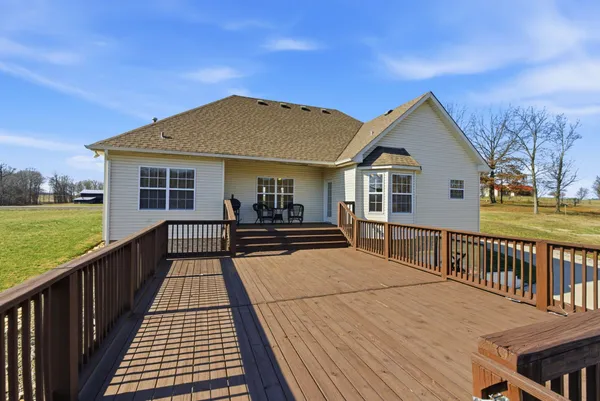a view of a house with a patio and a yard