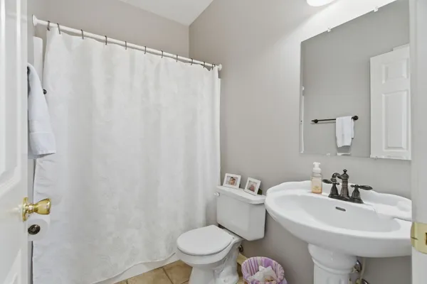 a white toilet sitting next to a bathroom sink