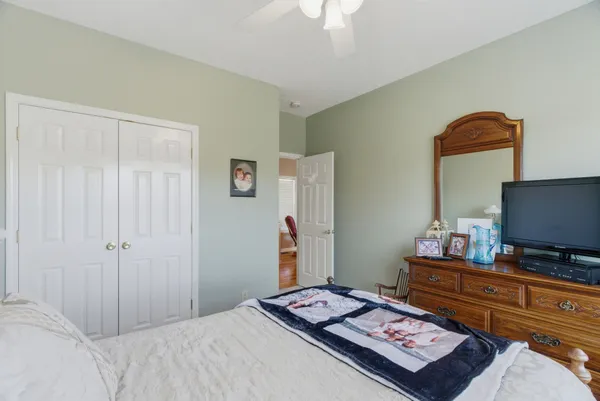 a bedroom with a bed and a flat screen tv