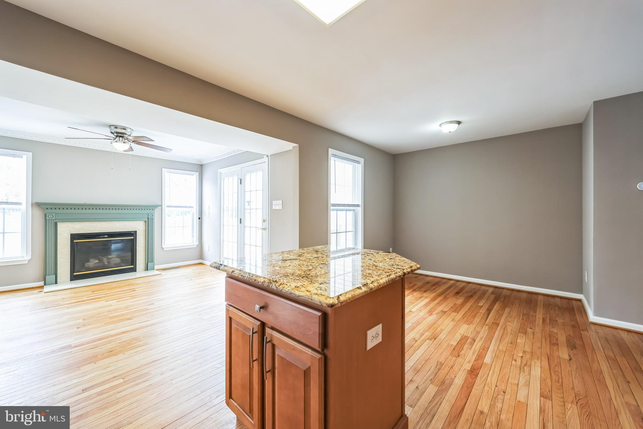 76 Millstream Road Pine Hill, NJ 08021 - Photo 13 of 30 an empty room with wooden floor and fireplace