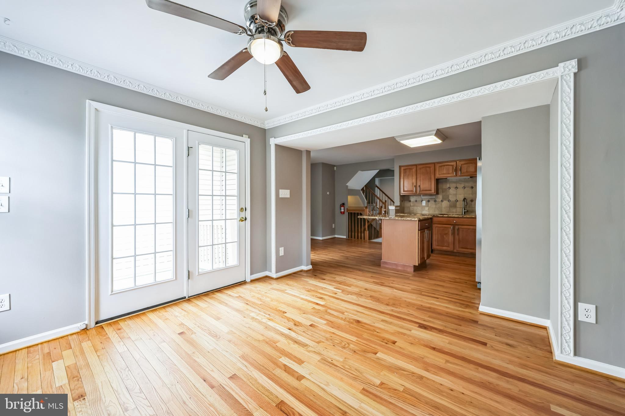 76 Millstream Road Pine Hill, NJ 08021 - Photo 18 of 30 a big room with wooden floor a ceiling fan and windows