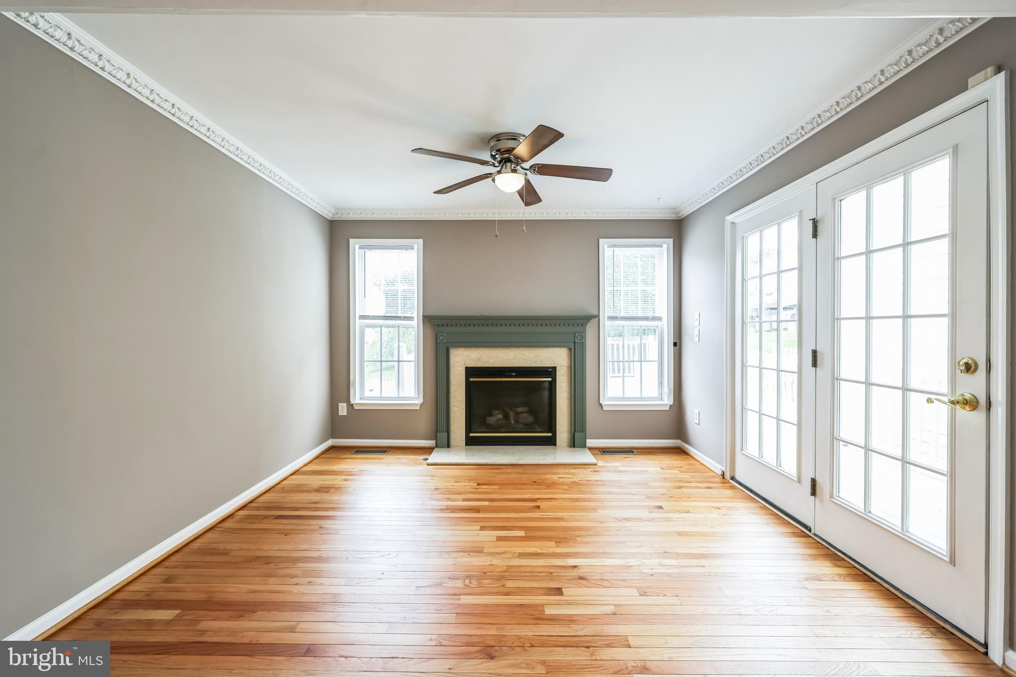76 Millstream Road Pine Hill, NJ 08021 - Photo 19 of 30 wooden floor fireplace and windows in an empty room