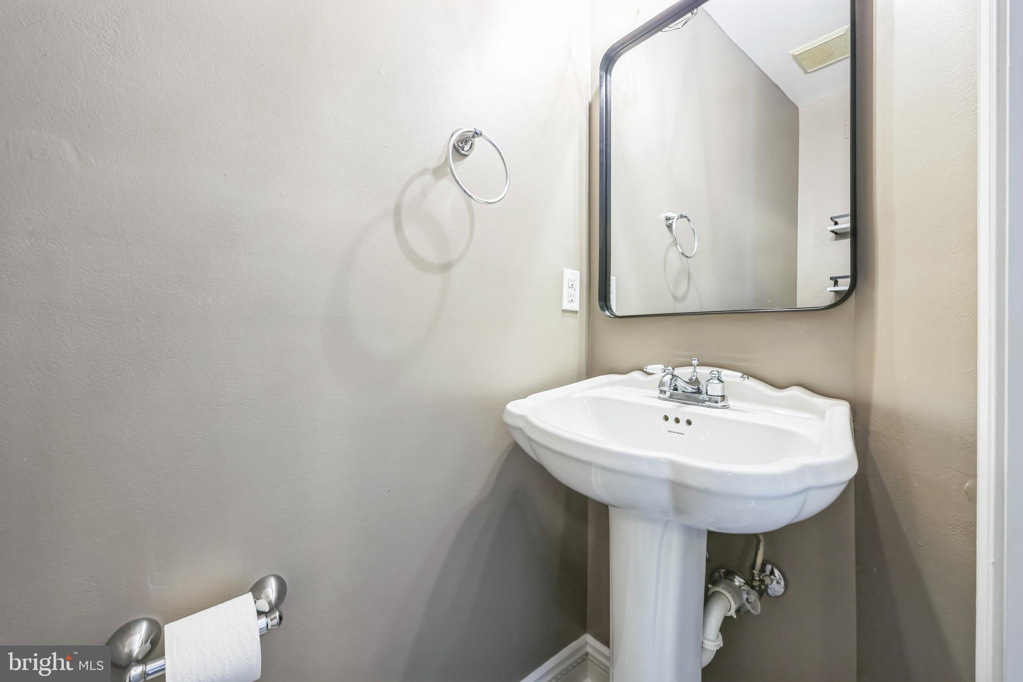 76 Millstream Road Pine Hill, NJ 08021 - Photo 7 of 30 a bathroom with a sink a mirror and toilet