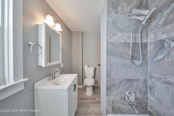 a bathroom with a sink toilet and shower
