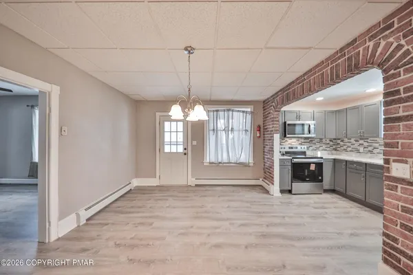 a view of an empty room with a kitchen