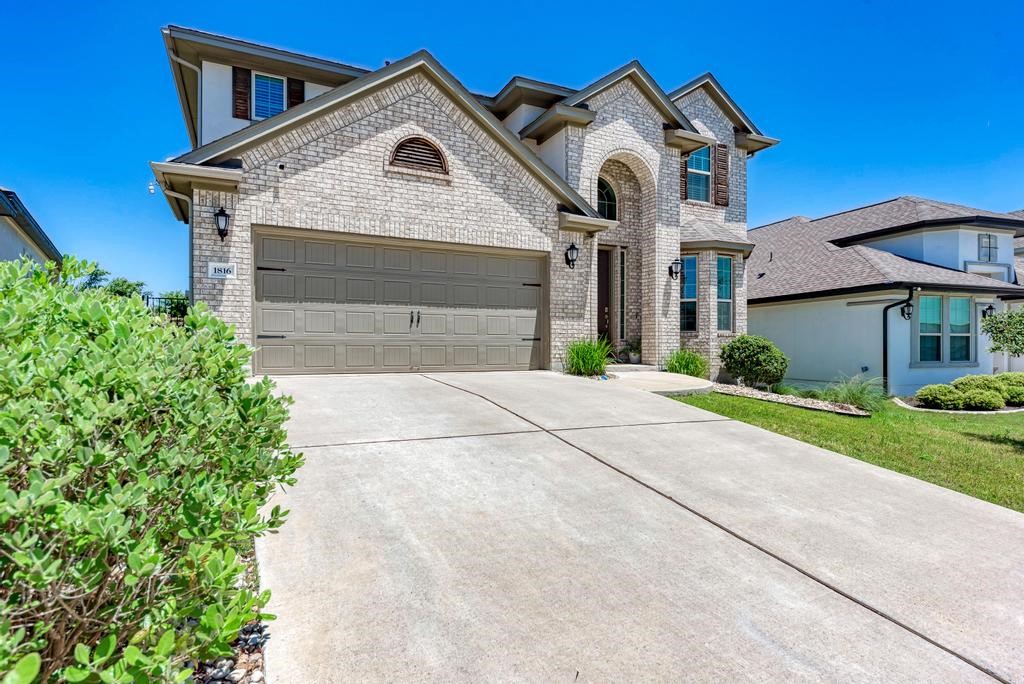 a front view of a house with a yard and garage