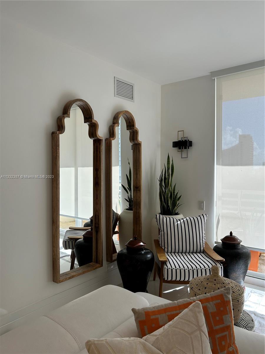 888 Brickell Key Drive, Unit 802 Miami, FL 33131 - Photo 19 of 42 a bedroom with furniture and a large window