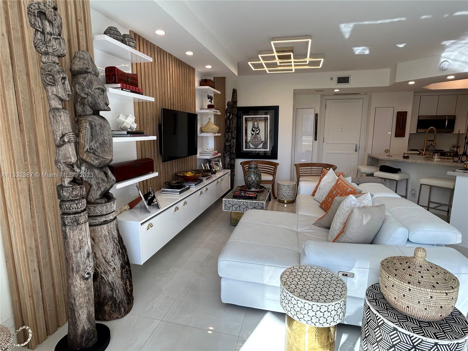 888 Brickell Key Drive, Unit 802 Miami, FL 33131 - Photo 21 of 42 a living room with furniture and a flat screen tv