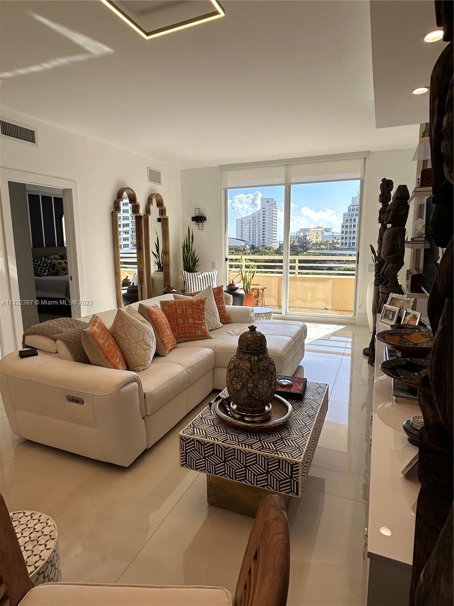 888 Brickell Key Drive, Unit 802 Miami, FL 33131 - Photo 22 of 42 a living room with furniture a flat screen tv and a large window