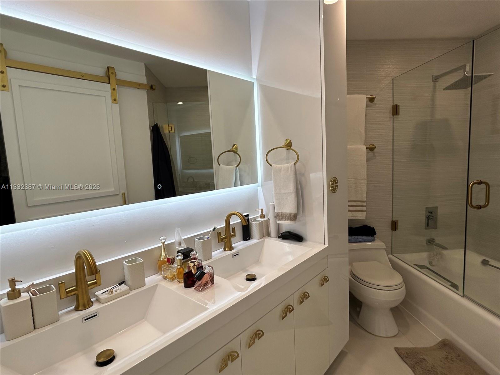 888 Brickell Key Drive, Unit 802 Miami, FL 33131 - Photo 23 of 42 a bathroom with a sink double vanity and toilet