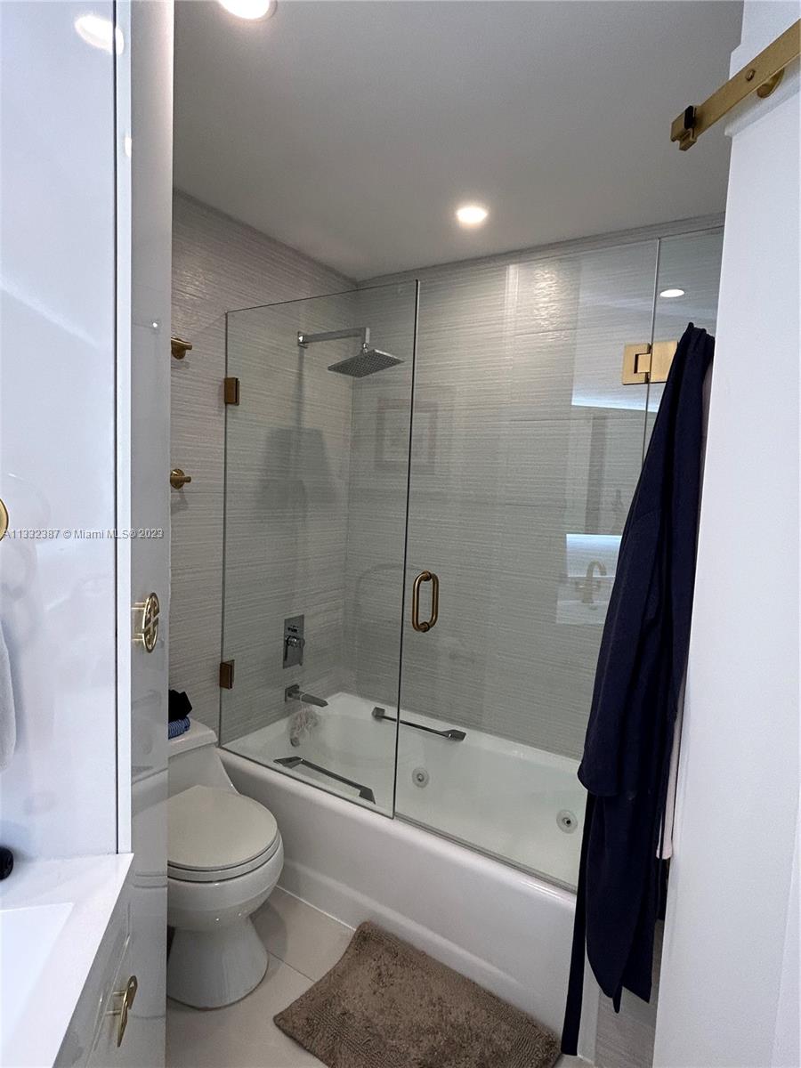 888 Brickell Key Drive, Unit 802 Miami, FL 33131 - Photo 25 of 42 a bathroom with a bathtub a toilet and a shower