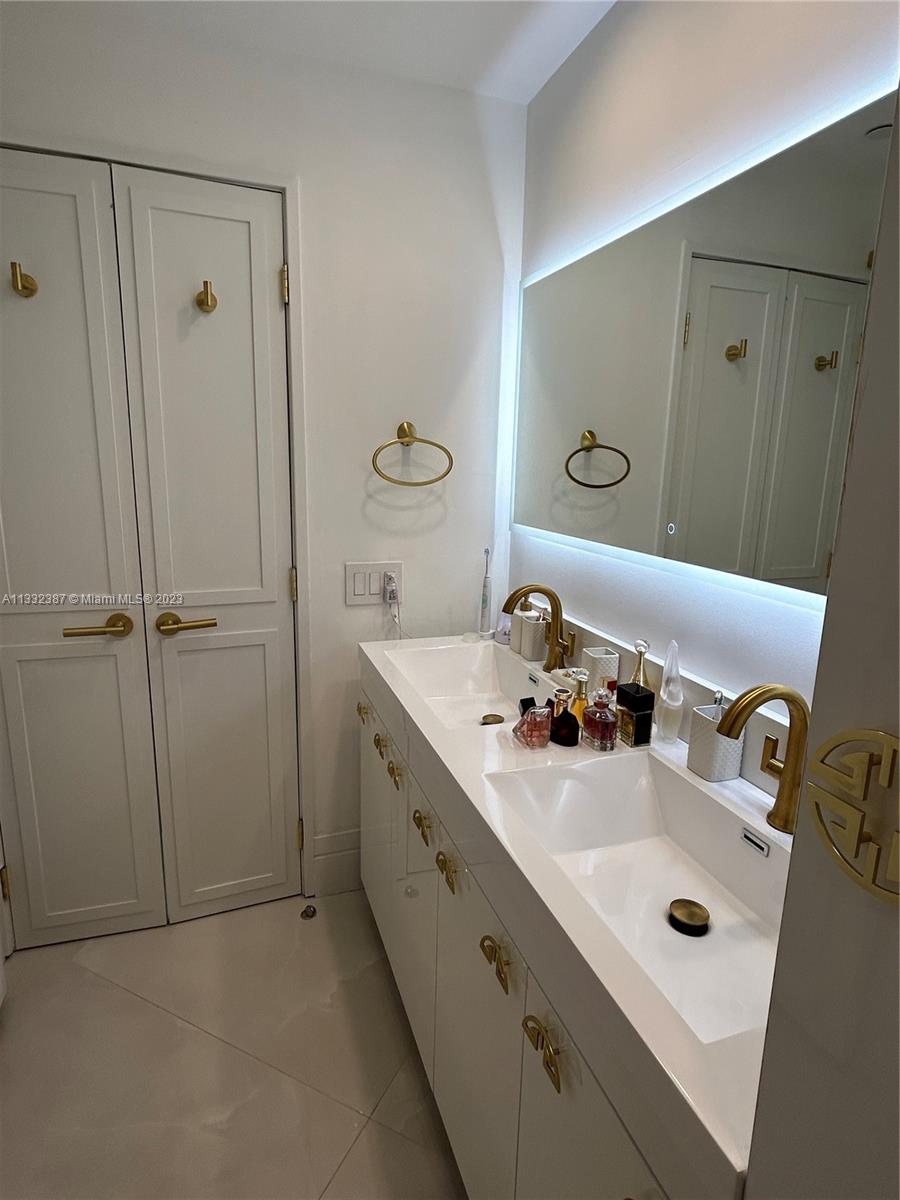 888 Brickell Key Drive, Unit 802 Miami, FL 33131 - Photo 27 of 42 a bathroom with a sink and mirror