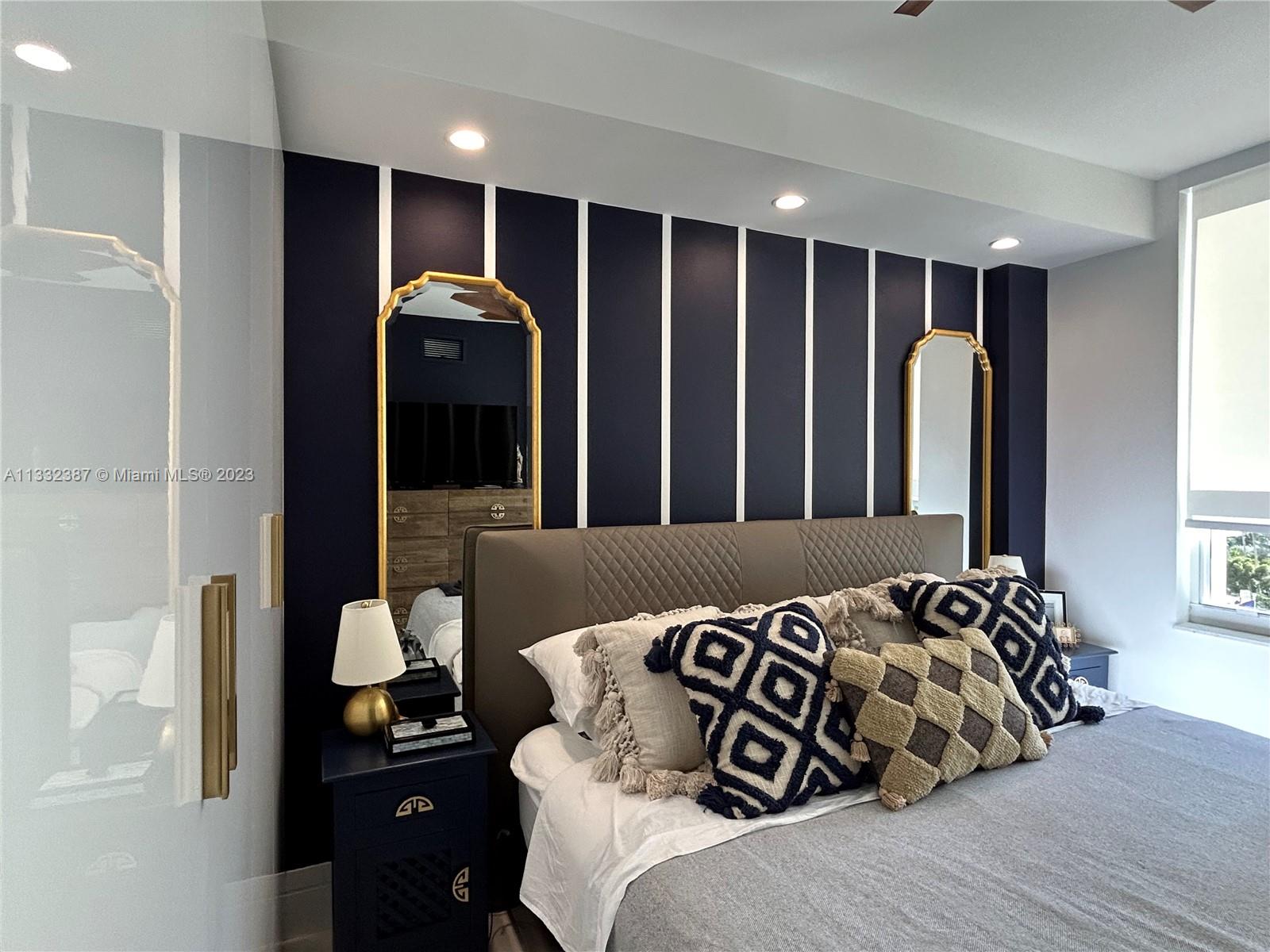 888 Brickell Key Drive, Unit 802 Miami, FL 33131 - Photo 29 of 42 a bed room with a bed and a television