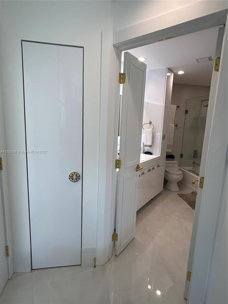 888 Brickell Key Drive, Unit 802 Miami, FL 33131 - Photo 30 of 42 a bathroom with a double vanity sink and a mirror